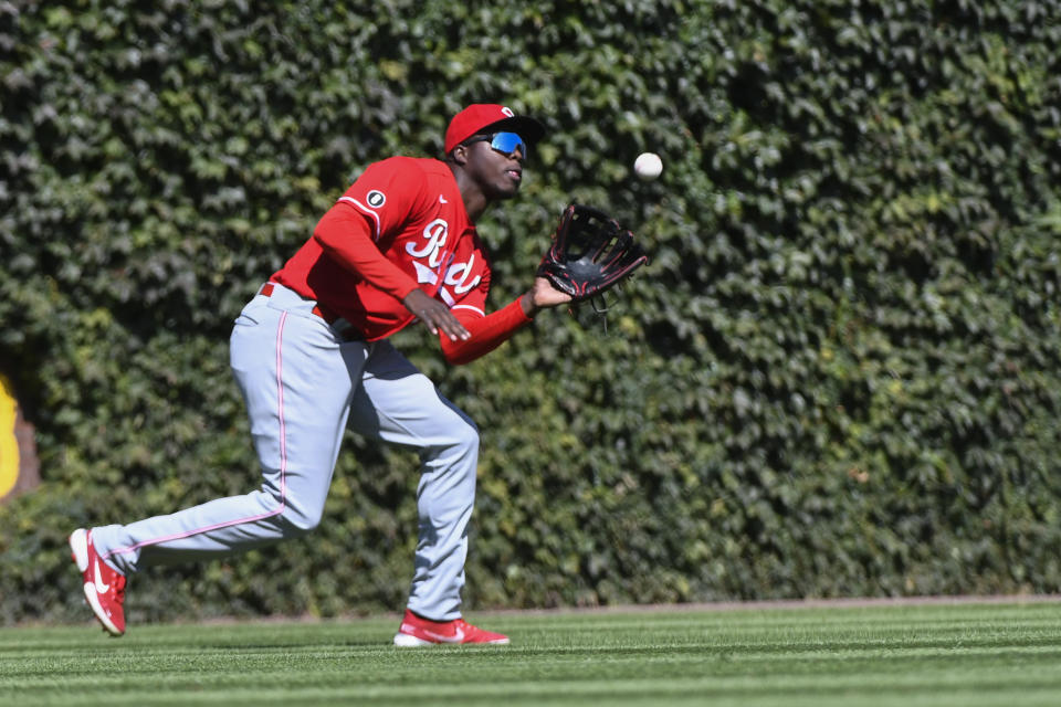 Cincinnati Reds left fielder Aristides Aquino catches a fly ball hit by Chicago Cubs' Willson Contreras during the fourth inning of a baseball game, Monday, Sept. 6, 2021, in Chicago. (AP Photo/Matt Marton)