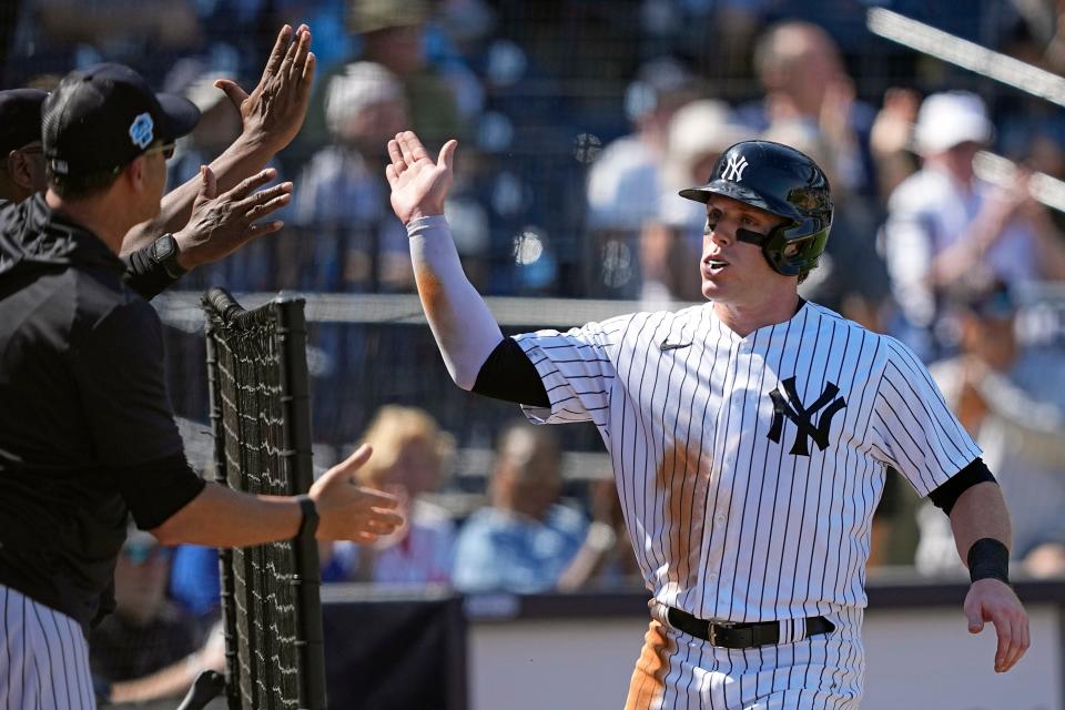 New York Yankees' Harrison Bader, right, celebrates after scoring on a wild pitch during the fourth inning of a spring training baseball game against the Washington Nationals Wednesday, March 1, 2023, in Tampa, Fla. (AP Photo/David J. Phillip)