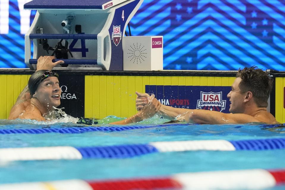 Nathan Adrian congratulates Caeleb Dressel after the men's 50 freestyle during wave 2 of the U.S. Olympic Swim Trials on Saturday, June 19, 2021, in Omaha, Neb. (AP Photo/Charlie Neibergall)