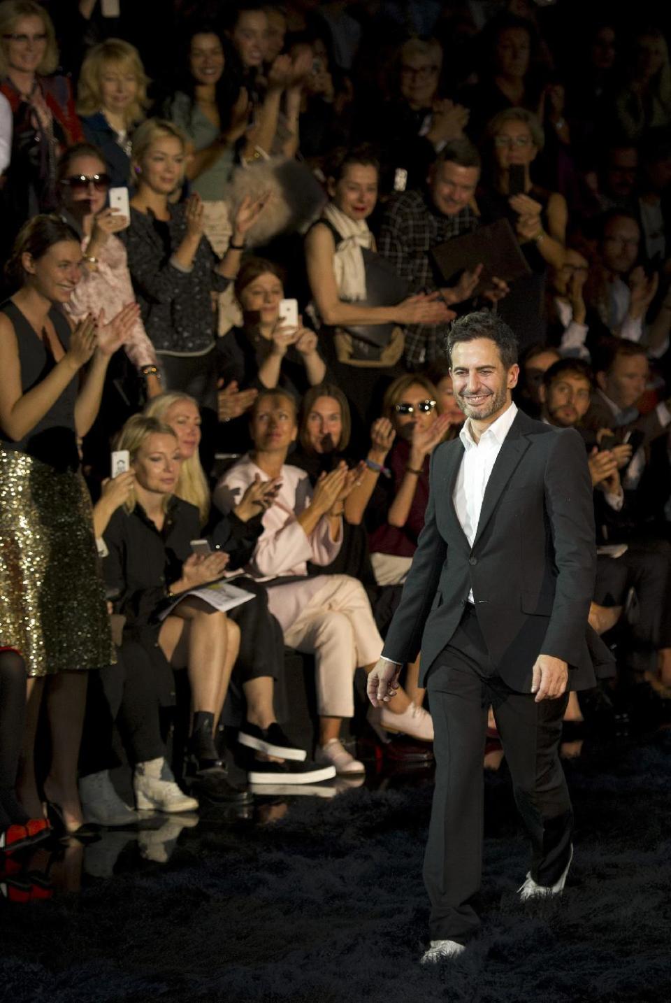 Fashion designer Marc Jacobs acknowledges applause following the presentation of the ready-to-wear Spring/Summer 2014 fashion collection he designed for Vuitton, Wednesday, Oct. 2, 2013 in Paris. (AP Photo/Jacques Brinon)