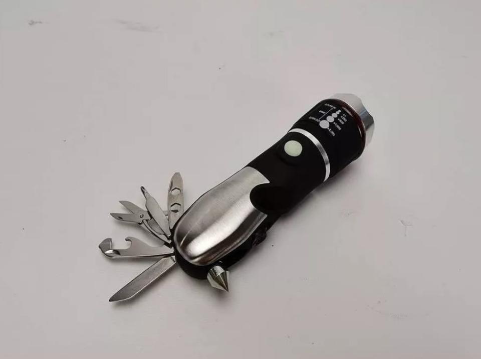 Black flashlight with stainless steel handle and stainless steel fold-out tools