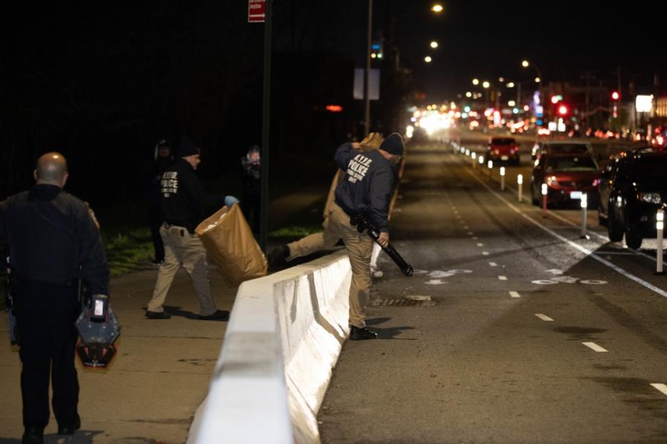 NYPD Crime Scene Unit officers carrying items to their cars. Robert Mecea