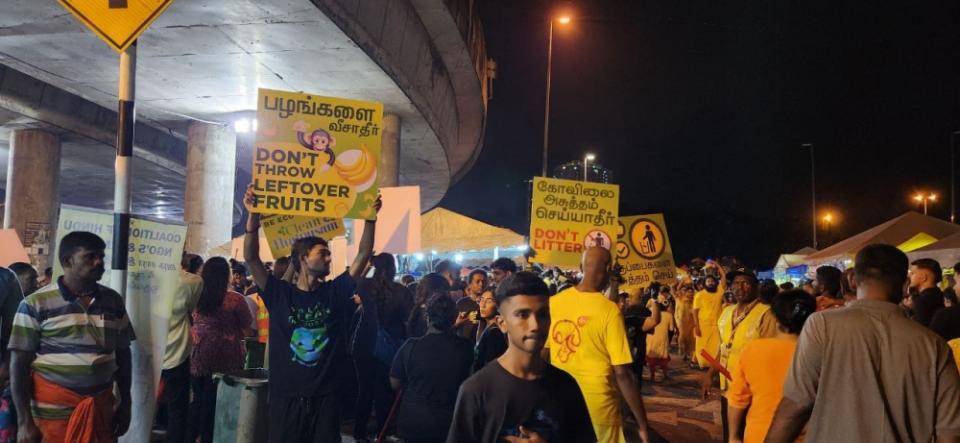 Clean Thaipusam volunteers went around Batu Caves area reminding the public to keep it clean. — Picture by Arif Zikri