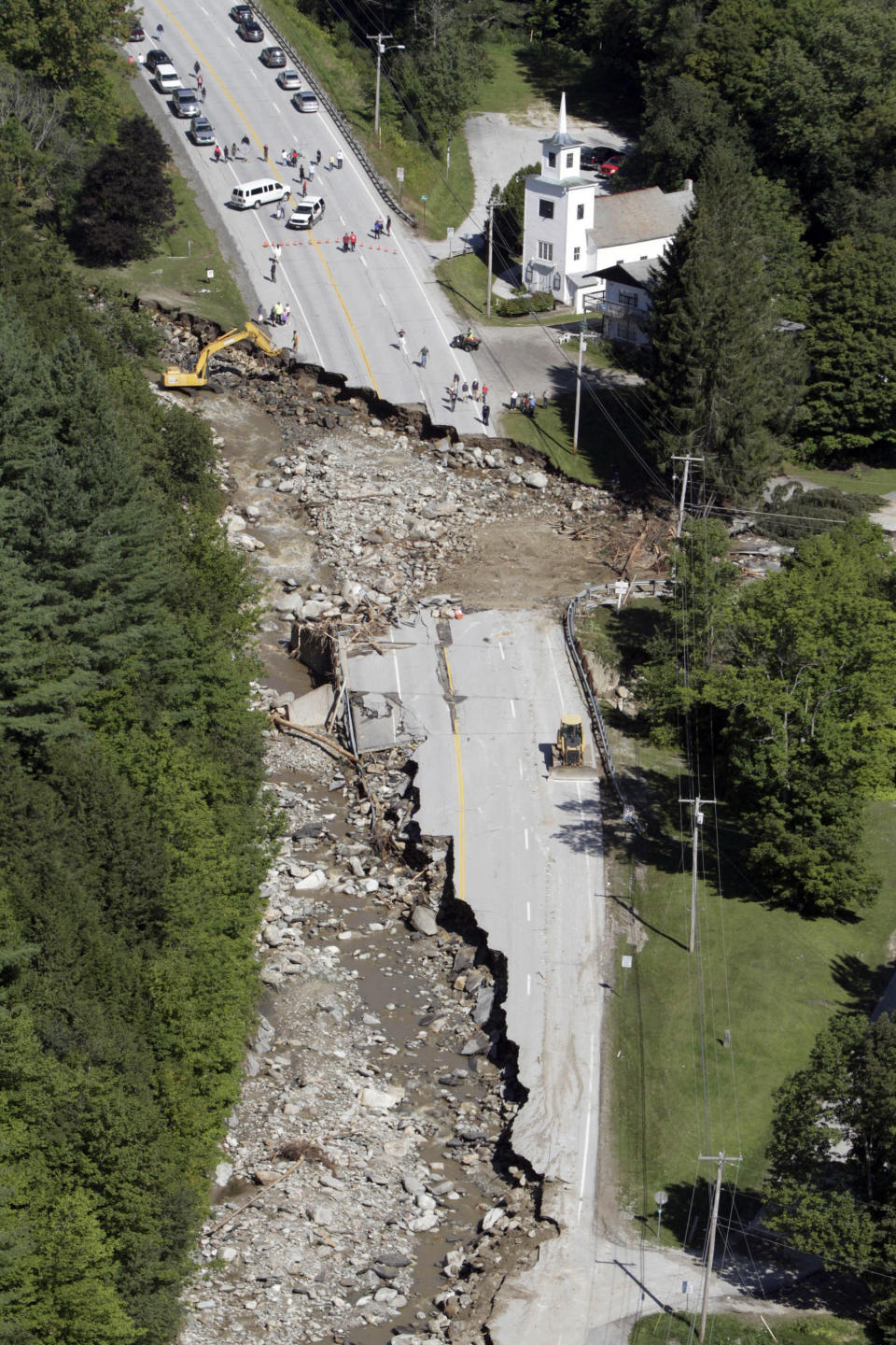 FILE -- This Aug. 30, 2011 file aerial photograph shows destruction of Route 4 in Killington, Vt., after Tropical Storm Irene passed through New England. Global warming is rapidly turning America into a stormy and dangerous place, with rising seas and disasters upending lives from flood-stricken Florida to the wildfire-ravaged West, according to a new U.S. federal scientific report released Tuesday, May 6, 2014. (AP Photo/Toby Talbot, File)