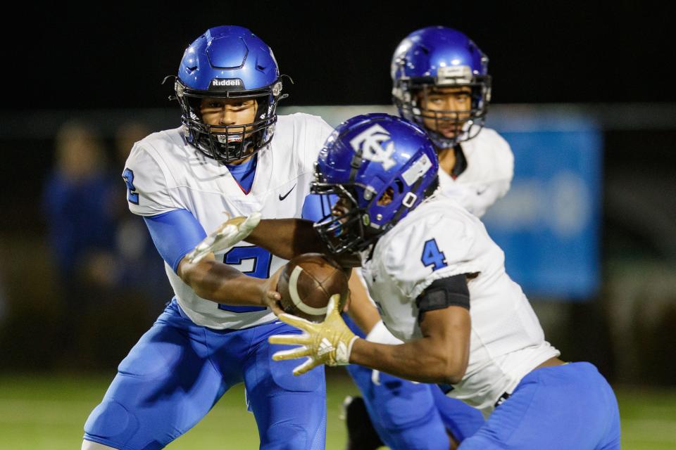 Trinity Christian's Colin Hurley (2) hands the ball off to Darnell Rogers (4) in the Class 2A State Championship game at Gene Cox on Thursday, Dec. 9, 2021.