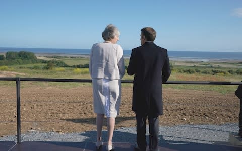 Theresa May and Emmanuel Macron take a moment to look out to sea in Normandy - Credit: PA