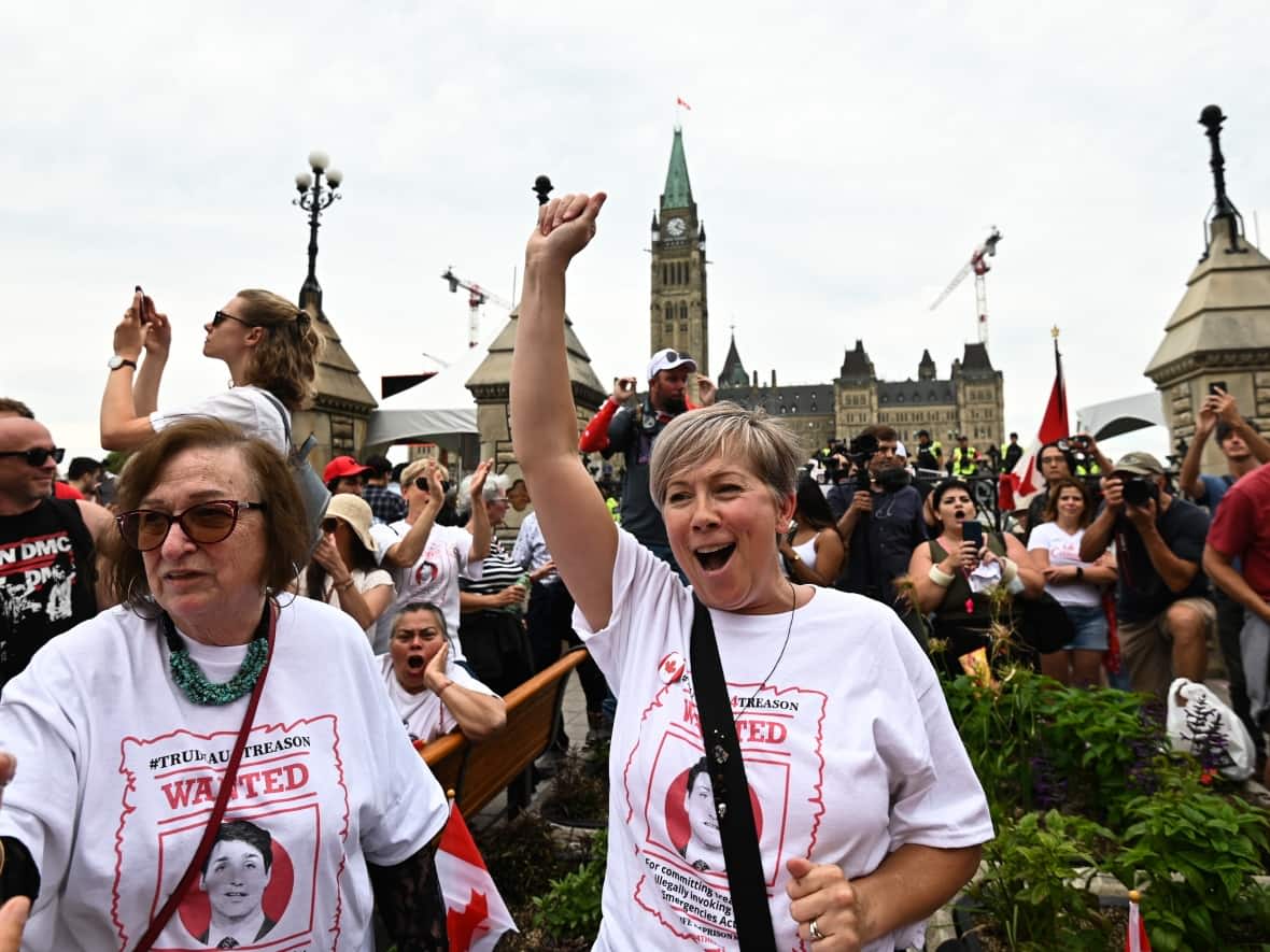People protesting against COVID-19 health measures take part in a demonstration in the downtown core of Ottawa during Canada Day celebrations on Friday, July 1, 2022.  (Spencer Colby/The Canadian Press - image credit)