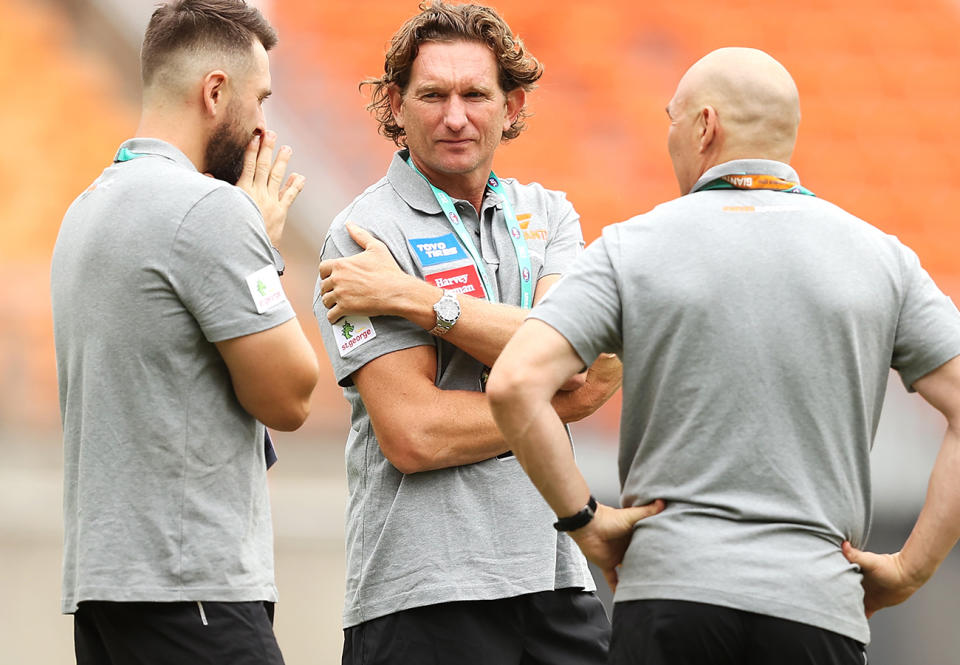 James Hird, pictured here speaking to other members of GWS Giants staff.