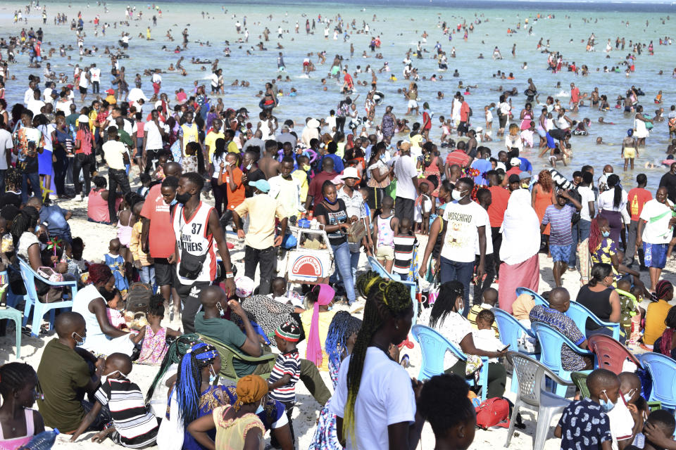 Hundreds of people crowd the Jomo Kenyatta public beach on Christmas day in Mombasa, Kenya, Friday, Dec. 25, 2020. Despite the World Health Organization's guidelines, many of the holiday makers had no masks on their faces or kept social distance which might increase the COVID-19 pandemic infections. The public beach had been closed down during this year's Easter holidays due to the COVID-19 pandemic but was recently opened to members of the public. (AP Photo)