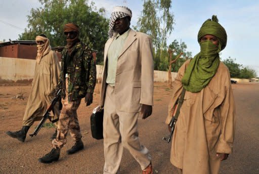 Fighters of the Islamist group Movement for Oneness and Jihad in West Africa (MUJAO) walk through Gao in July 2012. The north and east of Mali have fallen to Tuareg rebels and militias linked to Al-Qaeda