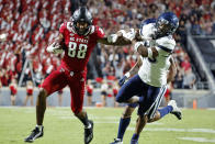 North Carolina State's Devin Carter (88) stiff-arms Connecticut's Chris Shearin (10) following a reception during the first half of an NCAA college football game in Raleigh, N.C., Saturday, Sept. 24, 2022. (AP Photo/Karl B DeBlaker)