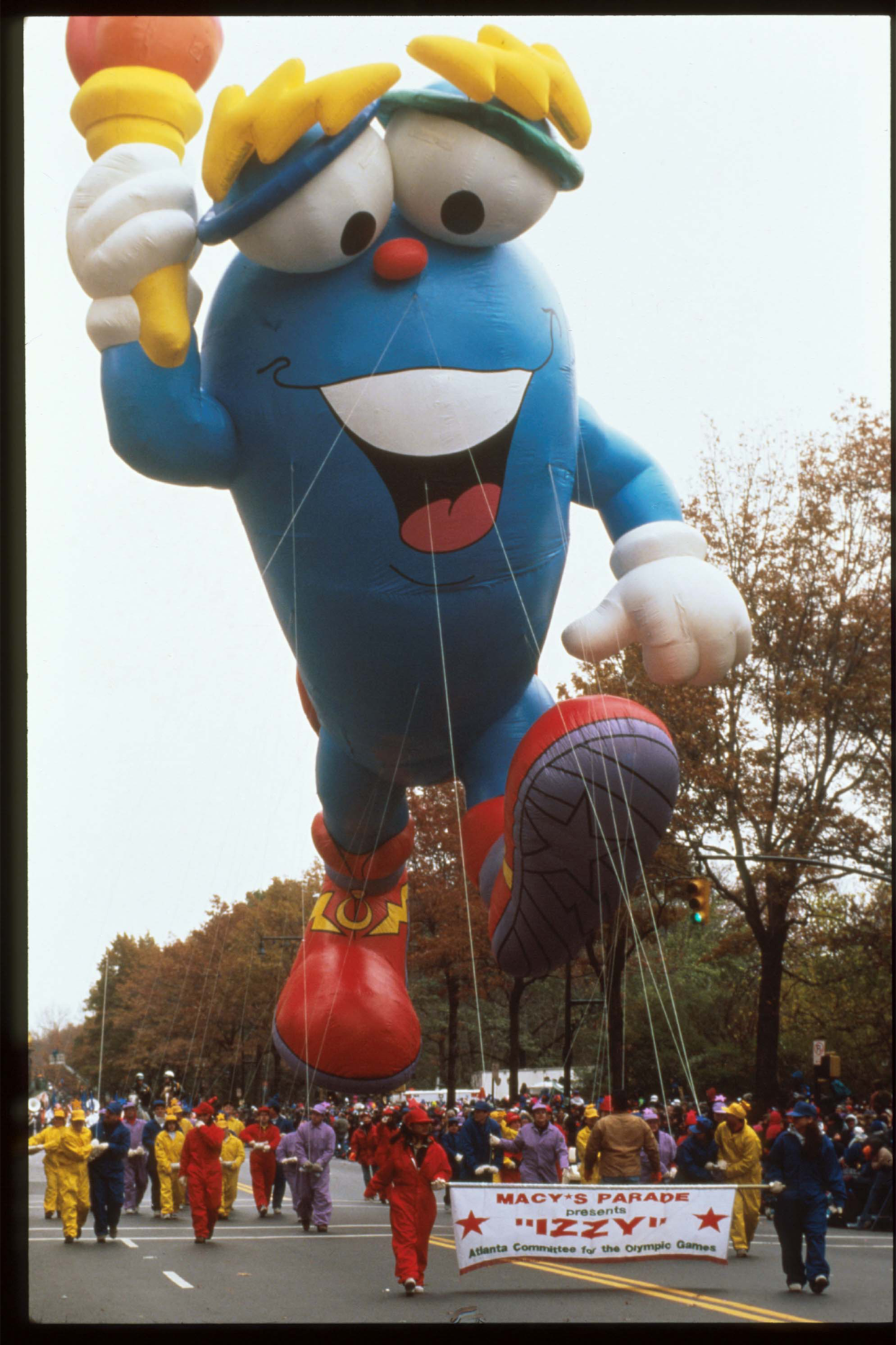 A giant balloon of Izzy, the olympic mascot, floats in the air at the 69th Macy's Thanksgiving Day Parade November 23, 1995