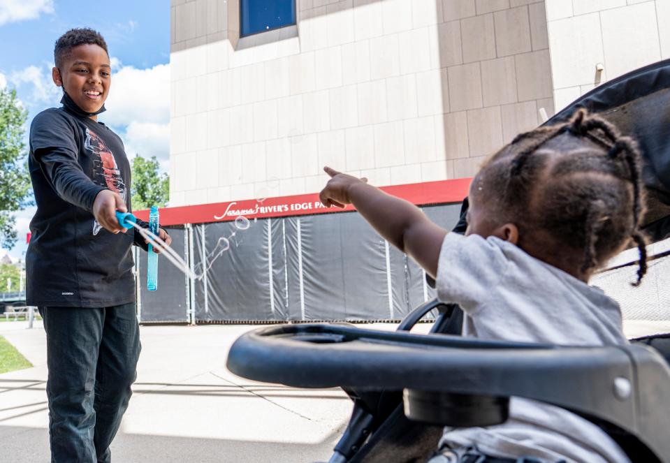 (Left) Tyler Reynolds, age 10, plays with his younger sibling (right) Antoine Reynolds II, age 2, who were with their mother Jasmine Reynolds of Milwaukee as they wait for the Black Arts MKE Youth Performing Arts Camp performance on Friday, July 29, 2022 at the Peck Pavilion.