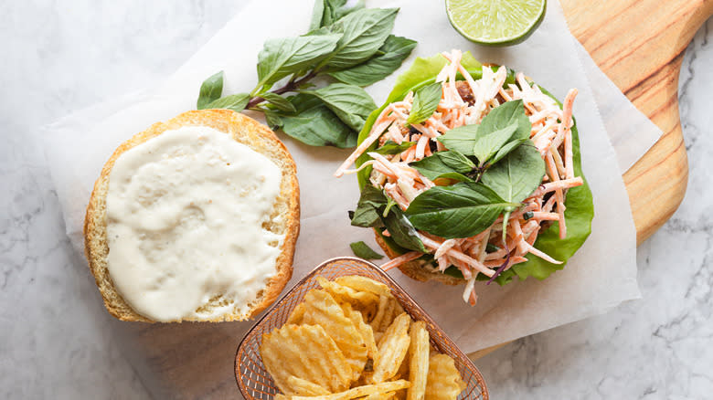 Overhead view of turkey burger with carrot slaw and Thai basil