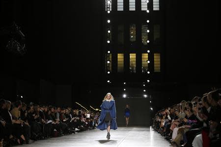 A model presents a creation from Topshop Unique Autumn/Winter 2014 collection during London Fashion Week February 16, 2014. REUTERS/Olivia Harris