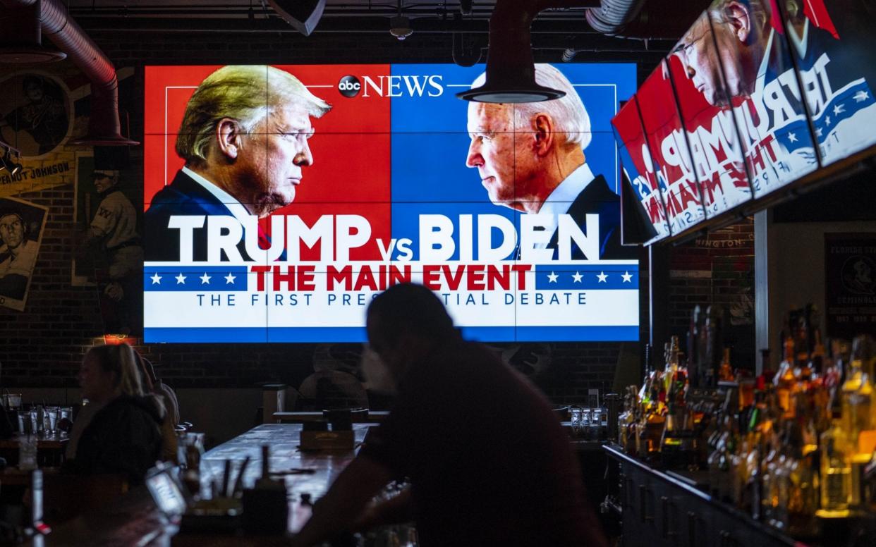 Television screens airing the first presidential debate are seen at Walters Sports Bar - Getty Images North America 