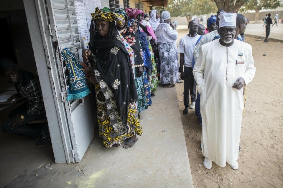 People line up to cast their votes during the presidential election at a polling station in Fatick, Senegal, Sunday Feb. 24, 2019. Senegalese voters are choosing Sunday whether to give President Macky Sall a second term in office as critics accused the incumbent leader of having blocked the strongest opposition candidates from running against him. (AP Photo)