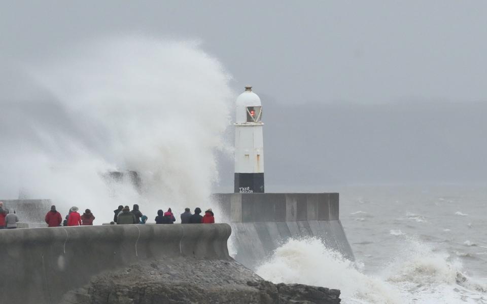 Waves battered the lighthouse at Porthcawl in Wales - PETER CZIBORRA/REUTERS