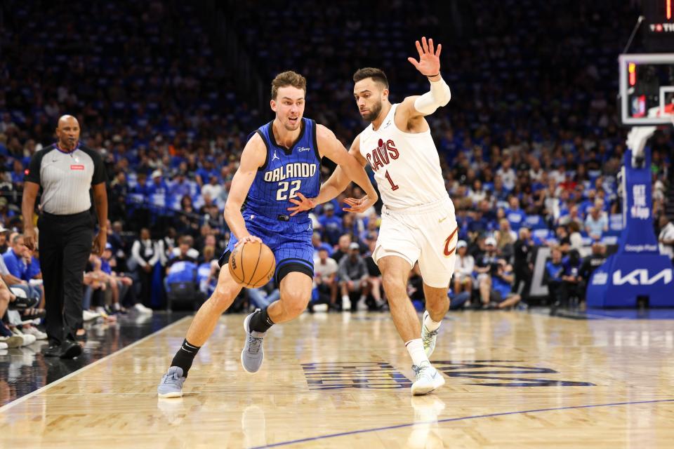 Apr 27, 2024; Orlando, Florida, USA; Orlando Magic forward Franz Wagner (22) drives the ball pas Cleveland Cavaliers guard Max Strus (1) in the first quarter during game three of the first round for the 2024 NBA playoffs at Kia Center. Mandatory Credit: Nathan Ray Seebeck-USA TODAY Sports