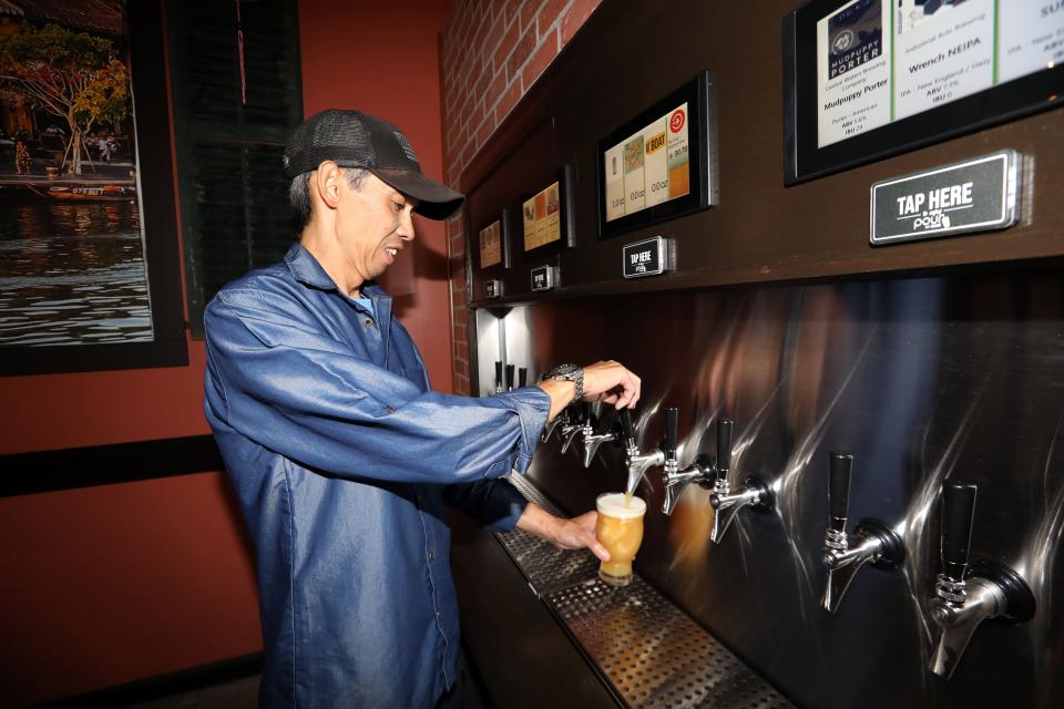 Owner Tai Nham shows how the self-pour system works at the new Mekong District One in Nyack Aug. 25, 2023. Nham, and his wife Fay Nham, opened the taproom next to their Vietnamese restaurant Mekong District in Nyack.