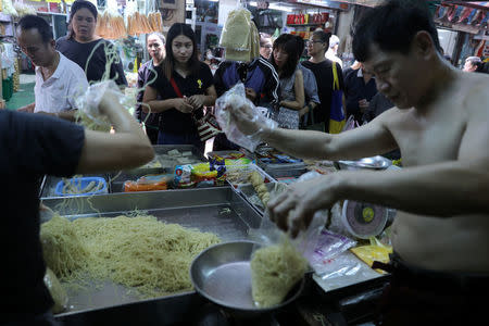 People shop for vegetarian food at a market in Chinatown Bangkok, Thailand, October 19, 2017. REUTERS/Athit Perawongmetha