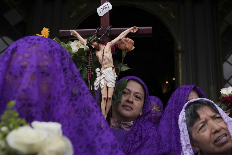 A penitent known as a Veronica carries a crucifix during the Jesus the Almighty Good Friday procession, as part of Holy Week celebrations, in Quito, Ecuador, Friday, March 29, 2024. Holy Week commemorates the last week of Jesus Christ’s earthly life which culminates with his crucifixion on Good Friday and his resurrection on Easter Sunday. (AP Photo/Dolores Ochoa)