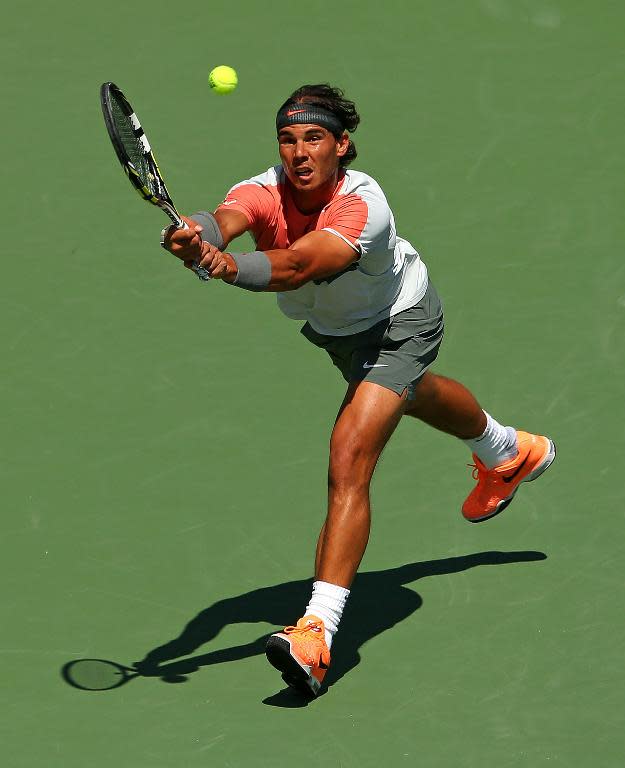 Rafael Nadal of Spain returns a shot to Novak Djokovic of Serbia on March 30, 2014 in Key Biscayne, Florida