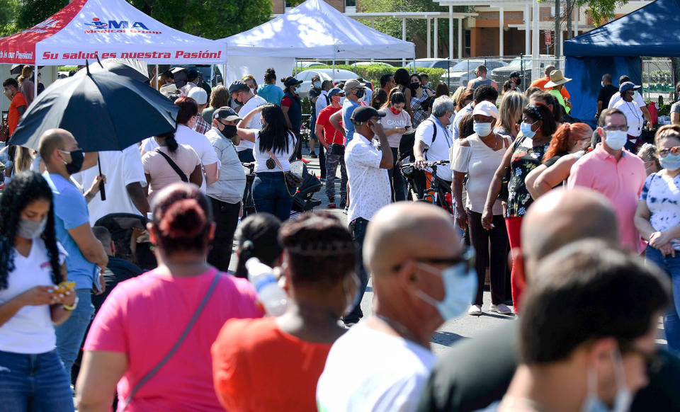 People wait in line for hours on April 9, 2021, at a pop-up COVID-19 vaccination site in the parking lot of Bravo Supermarket in a predominantly Black and Hispanic neighborhood in Orlando. The one-day mobile site offered 400 doses of the popular one-shot Johnson and Johnson vaccine.  (Photo: SOPA Images via Getty Images)