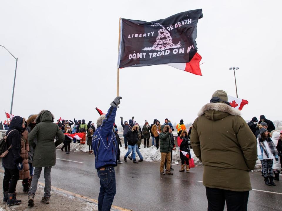 Supporters of an anti-vaccine mandate protest convoy bound for Ottawa cheer at the Vaughan Mills outlet mall in Vaughan, Ont., on Jan. 27, 2022. (Evan Mitsui/CBC - image credit)