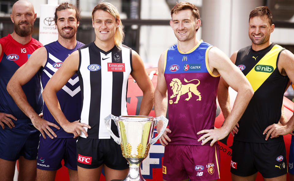 Darcy Moore and Harris Andrews with the AFL premiership cup.