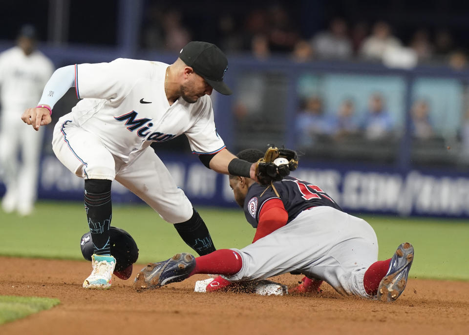 Washington Nationals Victor Robles (16) steals second base as Miami Marlins shortstop Miguel Rojas is late with the tag during the fifth inning of a baseball game, Wednesday, June 8, 2022, in Miami. (AP Photo/Marta Lavandier)