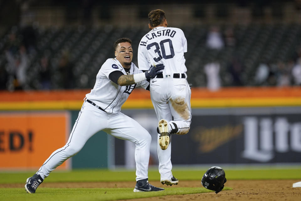 Detroit Tigers' Harold Castro (30) celebrates with Javier Baez after hitting the game winning single against the Kansas City Royals in the 10th inning of a baseball game in Detroit, Tuesday, Sept. 27, 2022. (AP Photo/Paul Sancya)