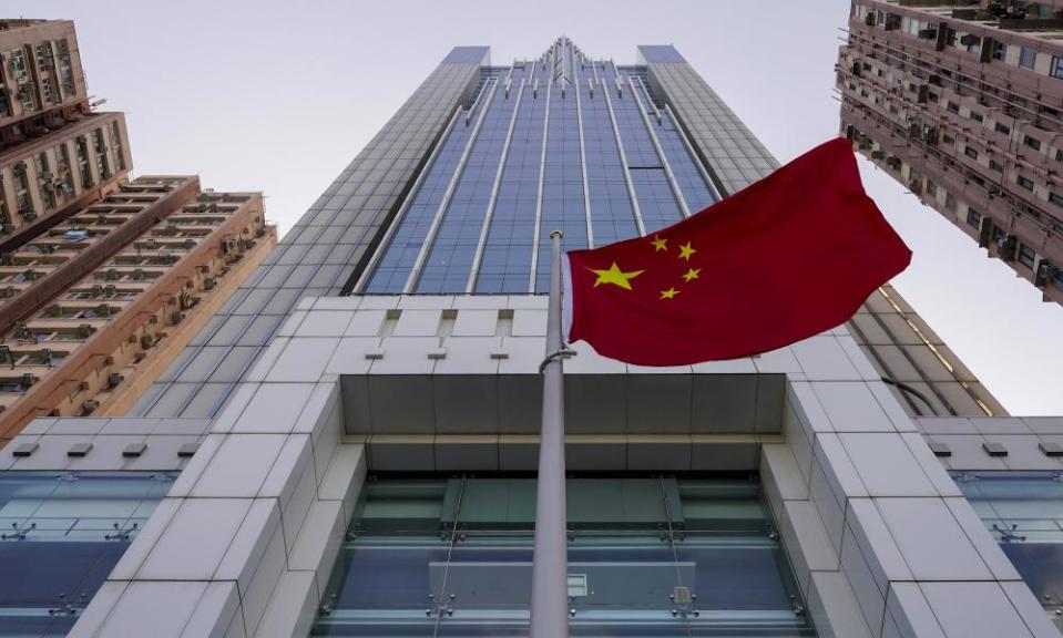 A national flag flutters in the breeze outside the China’s liaison office building in Hong Kong.