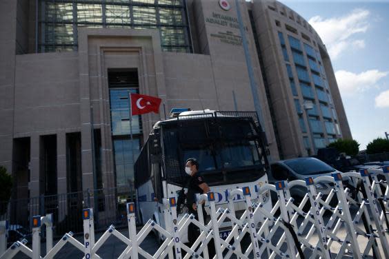 A police officer guards one of the entrances to the court in Istanbul (AP)
