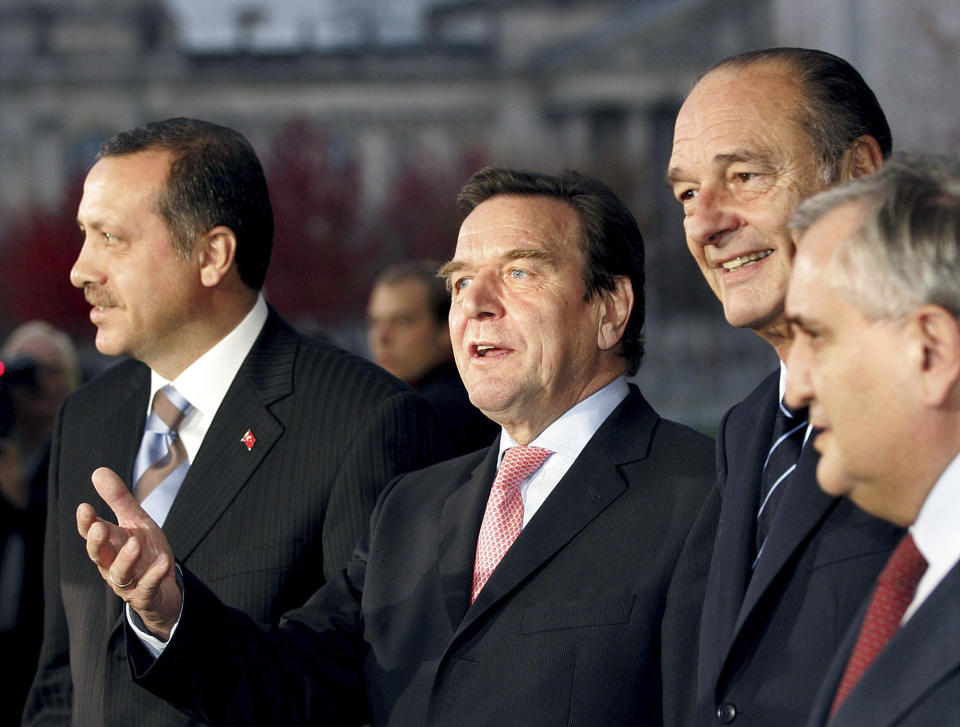 FILE - German Chancellor Gerhard Schroeder, second left, welcomes Turkish Prime Minister Recep Tayyip Erdogan, left, in Berlin on Oct. 26, 2004, before signing a deal on 36 European Airbus planes for Turkey with Erdogan and French President Jacques Chirac, second right. (AP Photo/Herbert Knosowski, File)