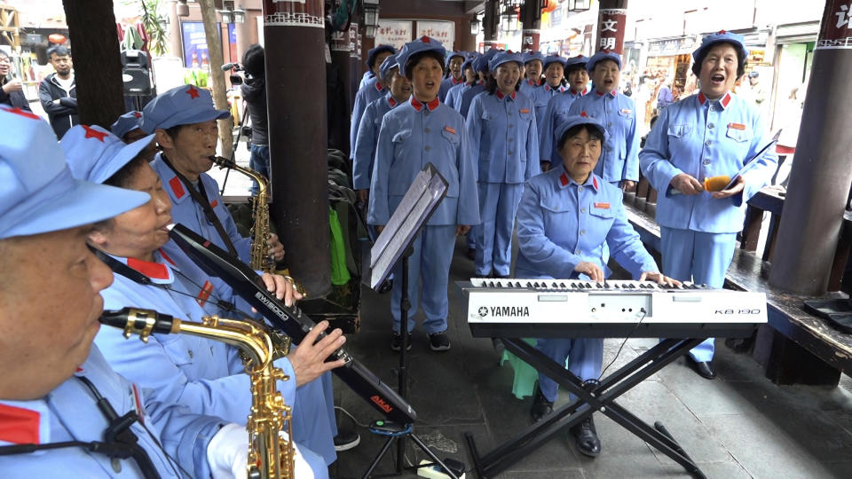 A group of local retirees gather to sing Red Army revolutionary songs in the city of Zunyi in Southwestern China's Guizhou province on April 12, 2021. The group, whose members' ages range from their late 50s to over 80, gather regularly to sing to tourists visiting the nearby Zunyi Memorial Museum. The museum, located at the site of the Zunyi Conference, was where the late Communist leader Mao Zedong rose to power. (AP Photo/Emily Wang)