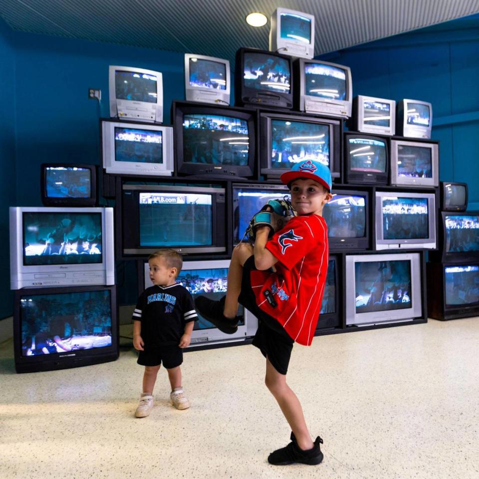 Riley Christiansen, 7, shows his best pitching stance as his younger brother Colton, 2, looks on while touring the Miami Marlins 30th Anniversary History Museum inside loanDepot Park on Wednesday, May 17, 2023.