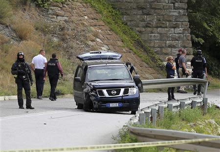 European Union police officers secure the site near Kosovo's town of Zvecan where one of their colleagues was shot dead, September 19, 2013. REUTERS/Bojan Slavkovic