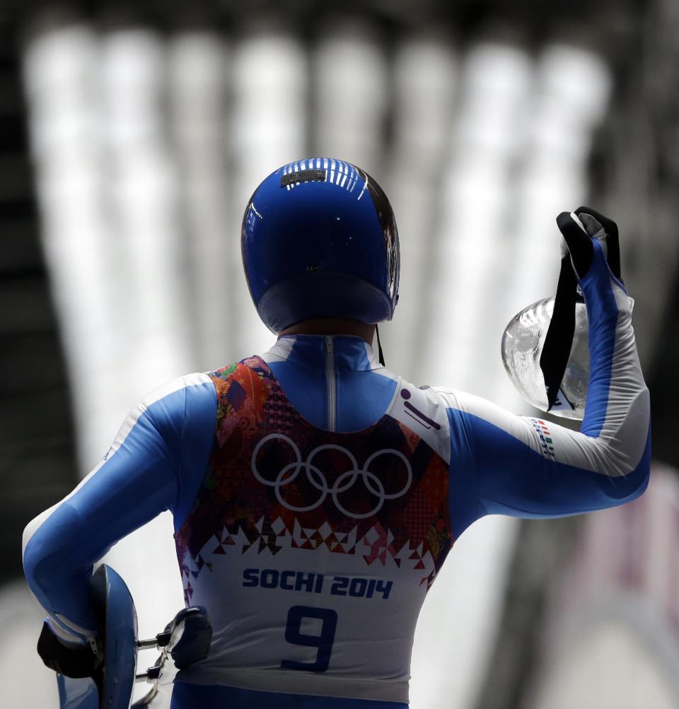 Armin Zoeggeler of Italy waves to supporters after finishing his second run during the men's singles luge competition at the 2014 Winter Olympics, Saturday, Feb. 8, 2014, in Krasnaya Polyana, Russia. (AP Photo/Dita Alangkara)