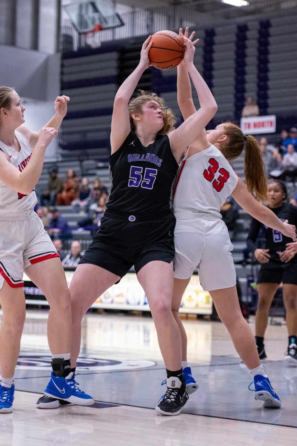 Brownsburg High School freshman Avery Gordon (55) attempts to get a shot away while being defended by Plainfield High School senior Jozee Rhodes (33) during the first half of an IHSAA Girls’ Sectional semi-final basketball game, Saturday, Feb. 5, 2022, at Brownsburg High School.