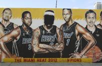 NBA superstar LeBron James' face image is covered over with black spray-paint in a mural of the championship team in the Wynwood district of Miami, Florida in this July 11, 2014 file photo. REUTERS/Zachary Fagenson/Files (UNITED STATES - Tags: TPX IMAGES OF THE DAY SPORT BASKETBALL)