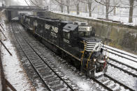 FILE - In this March 3, 2019, file photo a Norfolk Southern Railway Company freight train passes through Pittsburgh. More than two dozen major companies ranging from Campbell Soup to Kia filed anti-trust lawsuits on Sept. 30, 2019 against the nation's four largest railway companies, contending the railroads had a price-fixing scheme to illegally boost profits.(AP Photo/Gene J. Puskar, File)