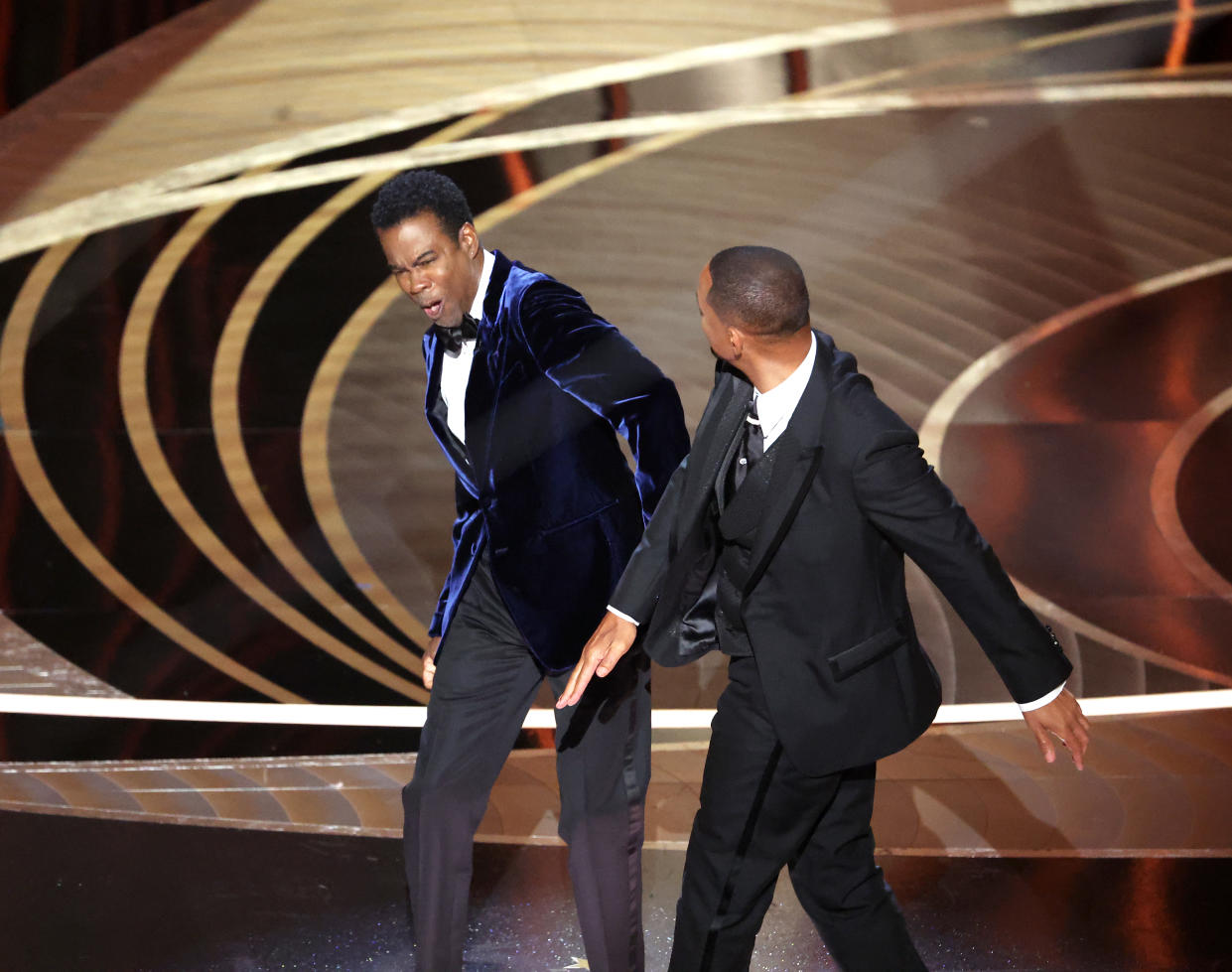 HOLLYWOOD, CA - March 27, 2022.    Chris Rock and Will Smith onstage during the show  at the 94th Academy Awards at the Dolby Theatre at Ovation Hollywood on Sunday, March 27, 2022.  (Myung Chun / Los Angeles Times via Getty Images)