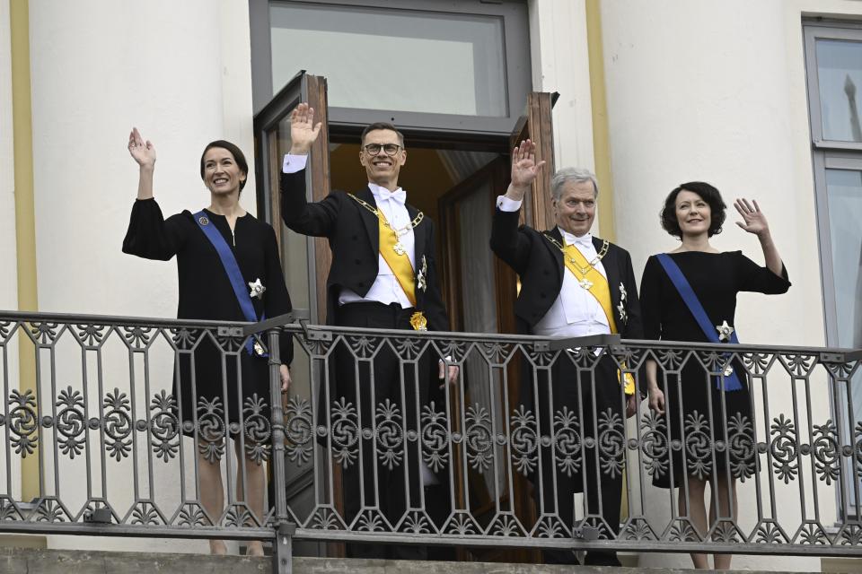 The new President of Finland Alexander Stubb, center left, and his spouse Suzanne Innes-Stubb, left, with outgoing President Sauli Niinisto and his spouse Jenni Haukio greet the public from the Palace balcony of the Presidential Palace during the inauguration of the President in Helsinki, Finland, Friday March 1, 2024. (Emmi Korhonen/Lehtikuva via AP)