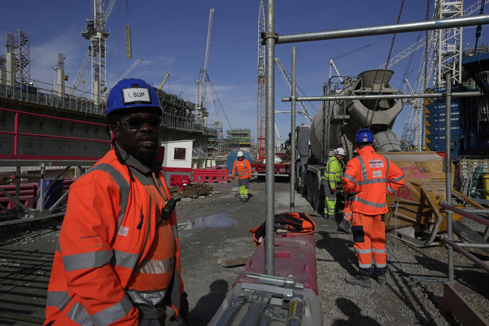 Workers work at the construction site of a turbine at Hinkley Point C nuclear power station in Somerset, England, Tuesday, Oct. 11, 2022. Some experts believe the future of large nuclear plants, particularly in Europe, will hinge in part on the success of Hinkley. (AP Photo/Kin Cheung)