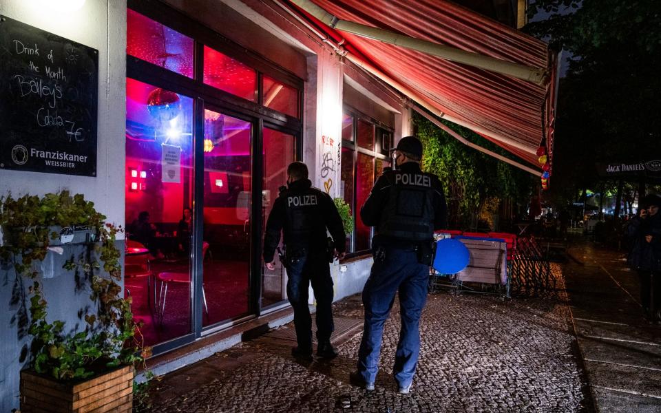 Police enforcing the 11pm curfew for restaurants and pubs in Berlin - Christophe Gateau/DPA