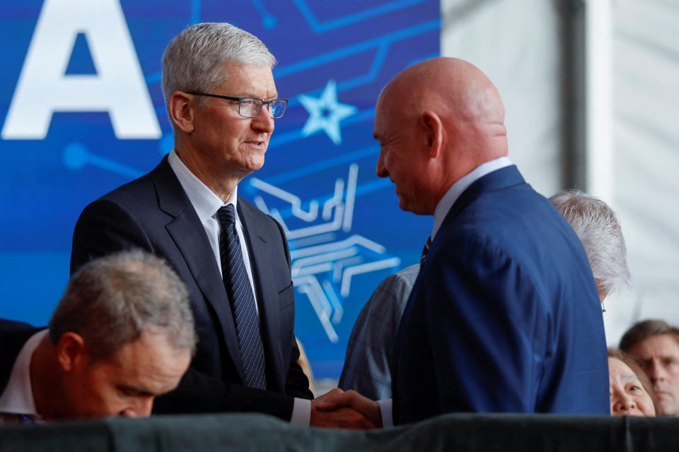 Apple's CEO Tim Cook greets U.S Senator Mark Kelly (D-AZ) during U.S. President Joe Biden's visit to TSMC AZ's first Fab (Semiconductor Fabrication Plant) in P1A (Phase 1A), in Phoenix, Arizona, U.S. December 6, 2022. REUTERS/Jonathan Ernst