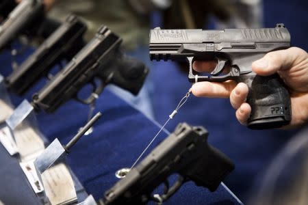 A Walther handgun is displayed at the Smith & Wesson booth at the Safari Club International Convention in Reno, Nevada, January 29, 2011. REUTERS/Max Whittaker