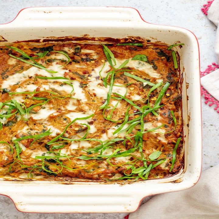 A casserole of spaghetti squash mixed with cheese and spinach