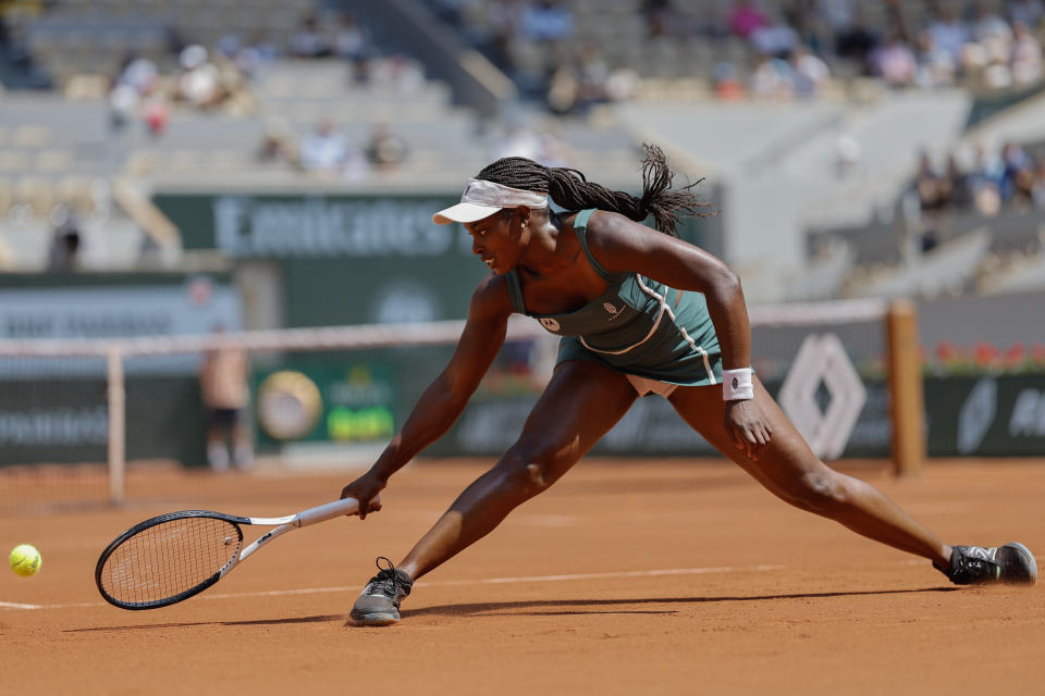 Sloane Stephens of the U.S. slides t play a shot against Karolina Pliskova of the Czech Republic during their first round match of the French Open tennis tournament at the Roland Garros stadium in Paris, Monday, May 29, 2023. (AP Photo/Jean-Francois Badias)